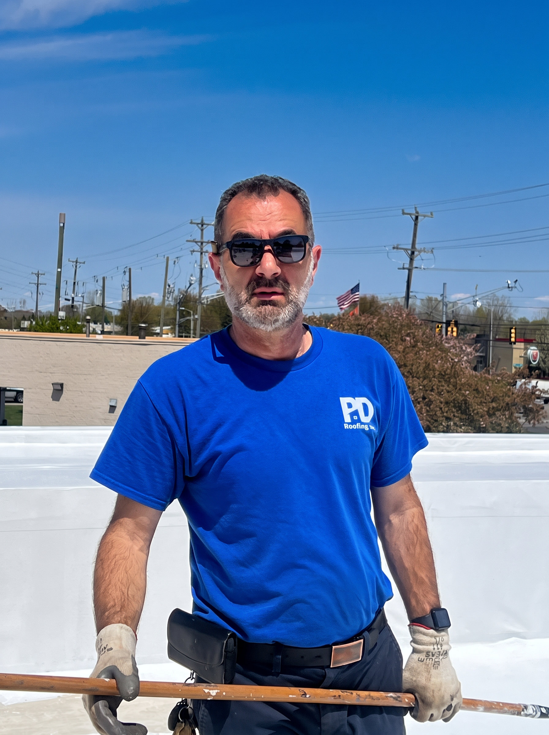 Peter Dema, owner of P D Roofing, working on a flat commercial roof